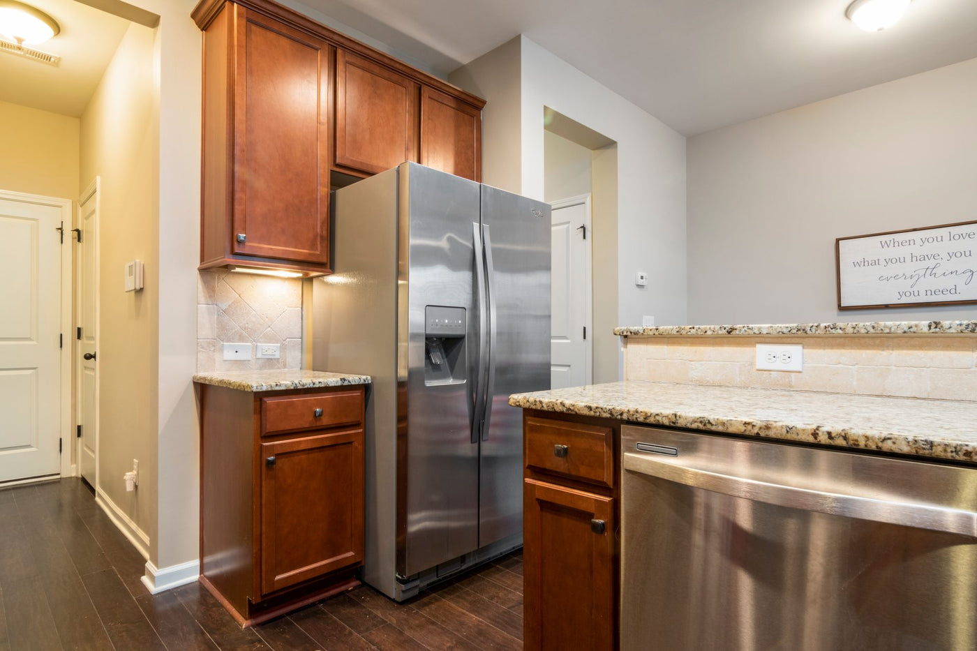 Elegant kitchen interior featuring stainless steel appliances and wooden cabinets.